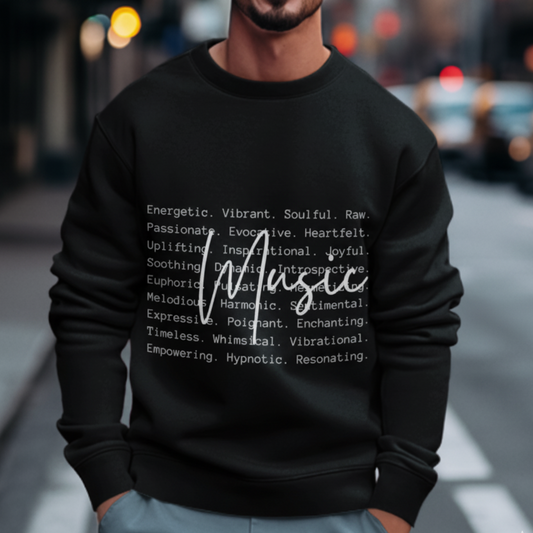 Person wearing a black sweatshirt with text design on a blurred city street background