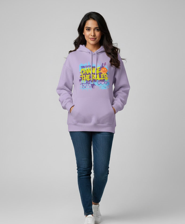Woman wearing a light purple hoodie with colorful text design on a white background