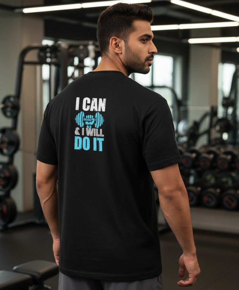 Man wearing a black t-shirt with motivational text in a gym setting