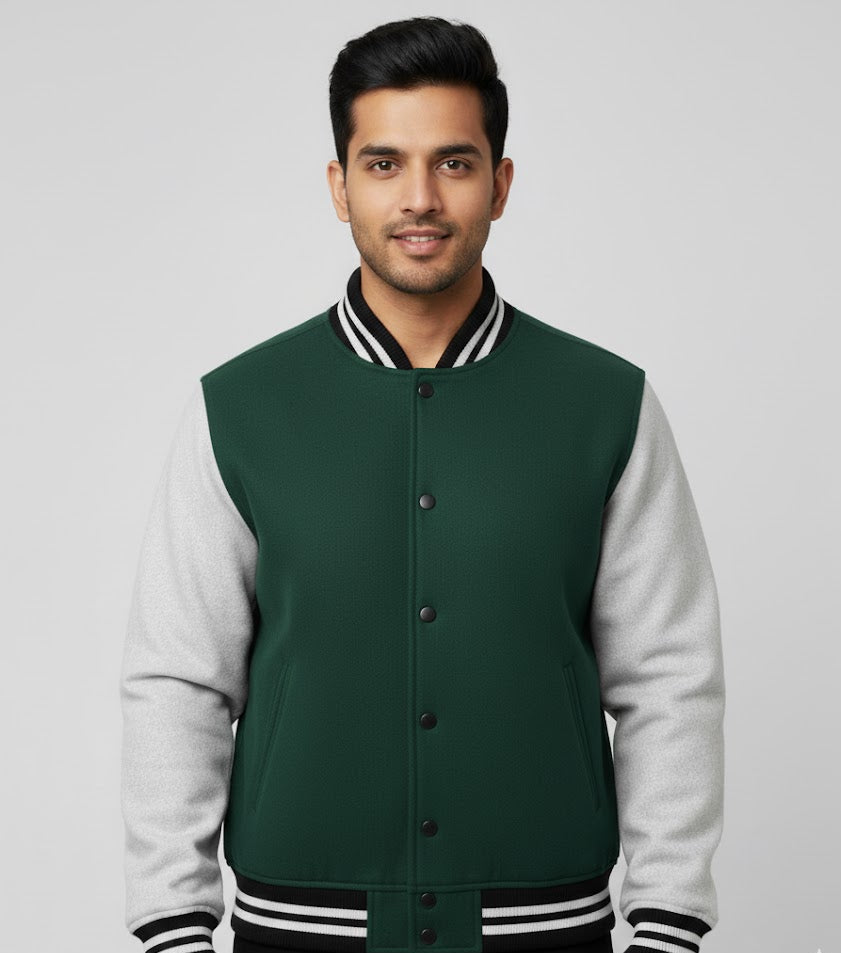Man wearing a green and gray varsity jacket on a gray background