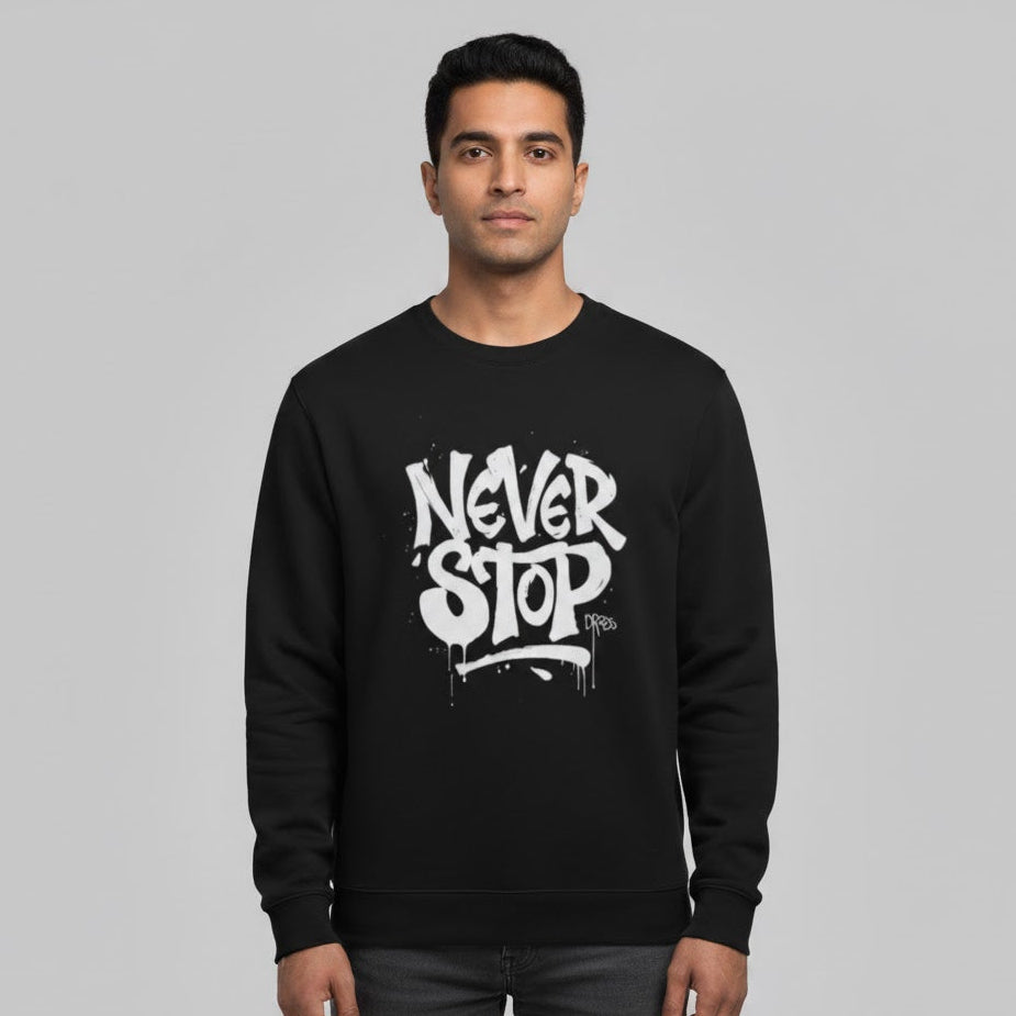Person wearing a black sweatshirt with 'Never Stop' text on a gray background