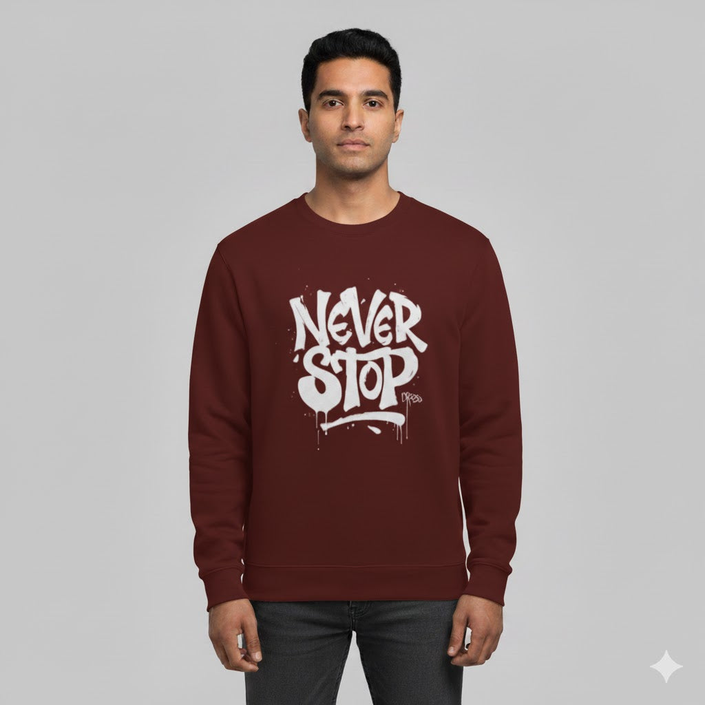 Man wearing a maroon sweatshirt with 'NEVER STOP' text on a gray background