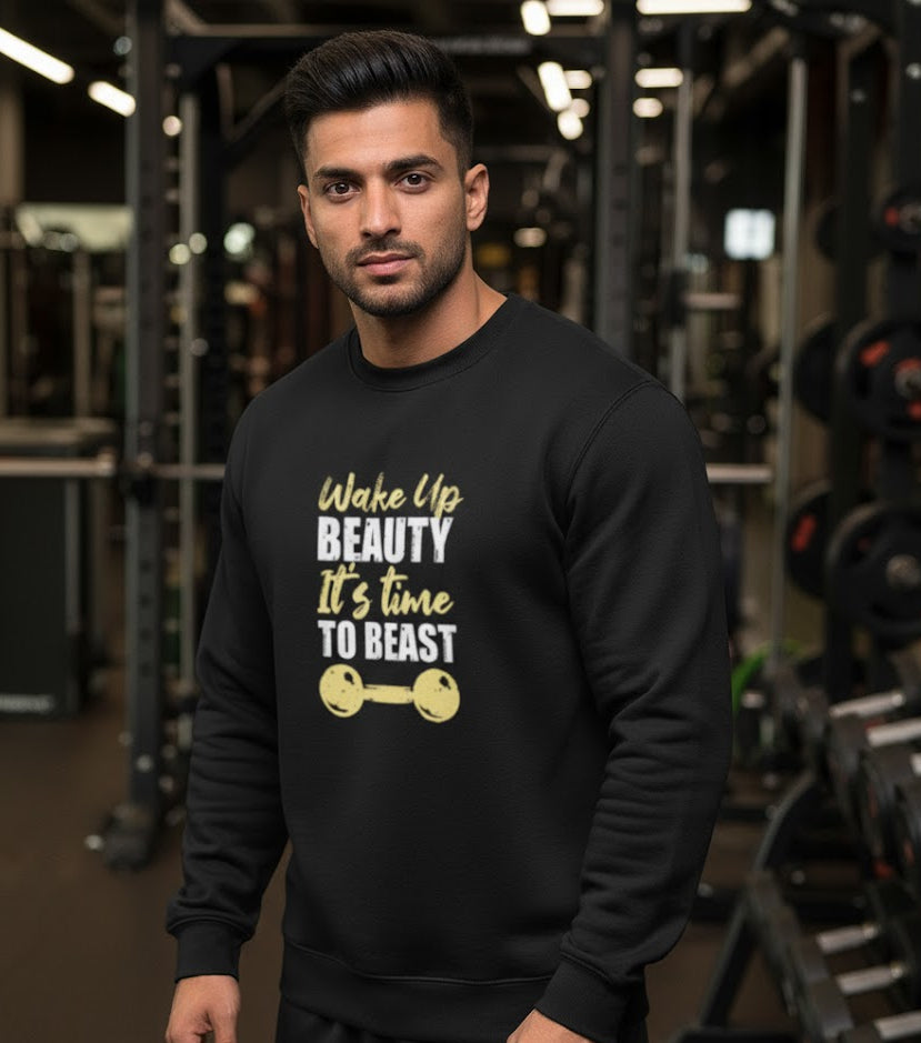 Man wearing a black sweatshirt with motivational text in a gym setting